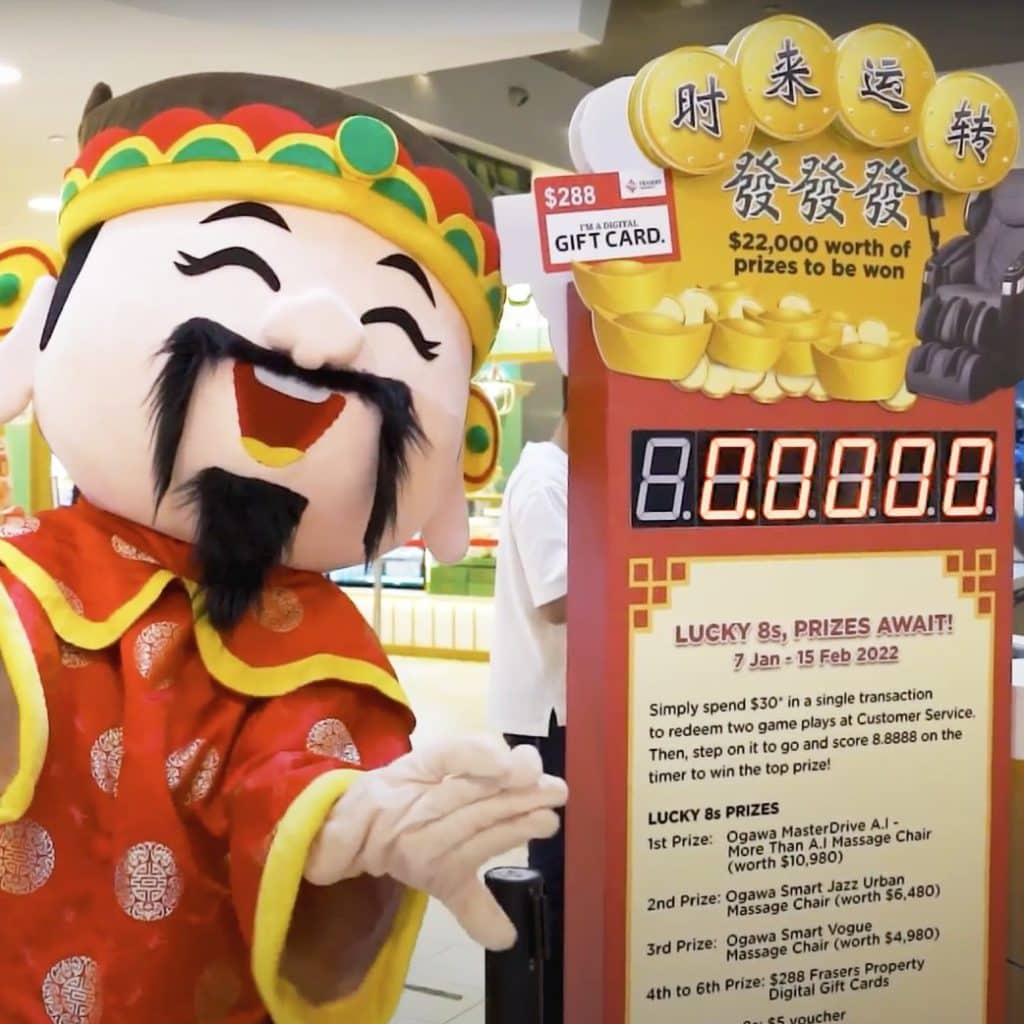 Chinese God of Fortune mascot standing next to a 'Lucky 8s, Prizes Await!' game machine for a Chinese New Year experiential events